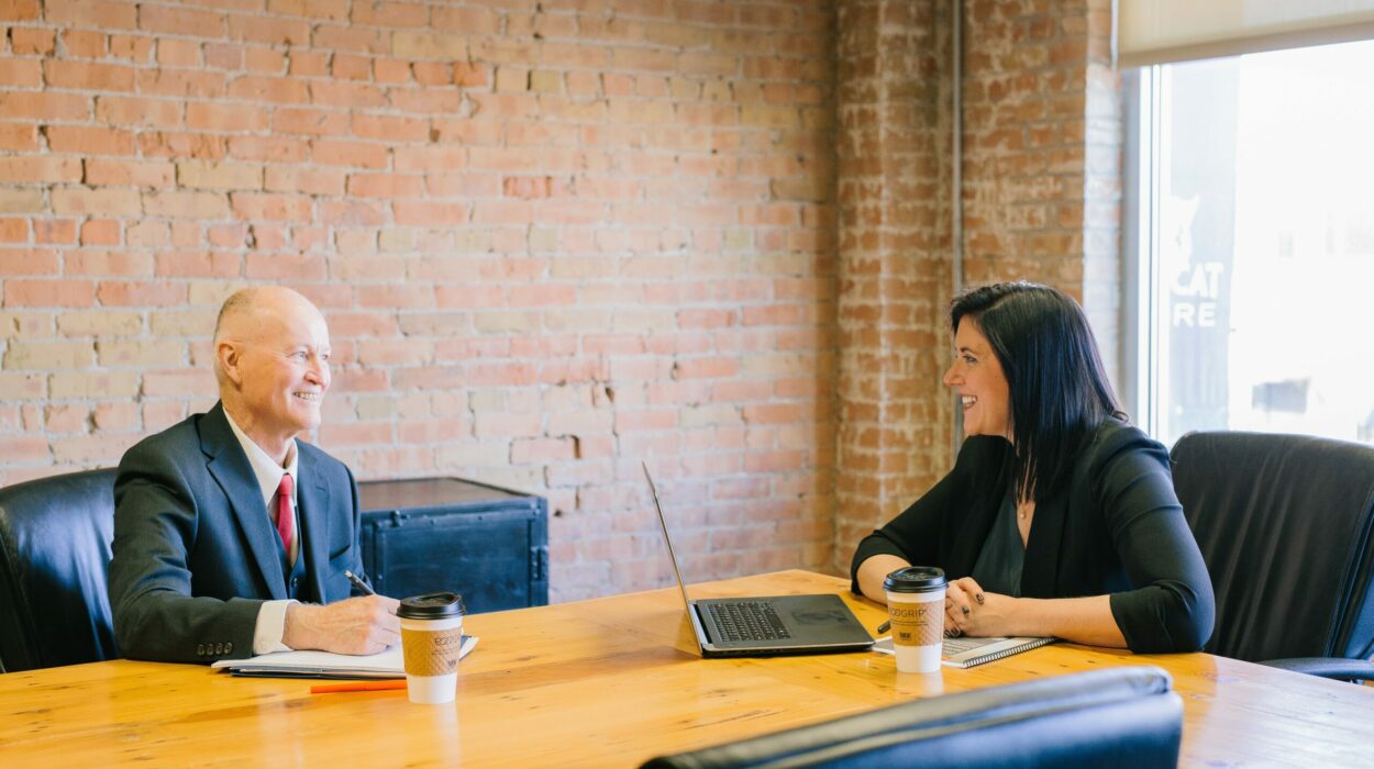 Man and woman inside office laughing together