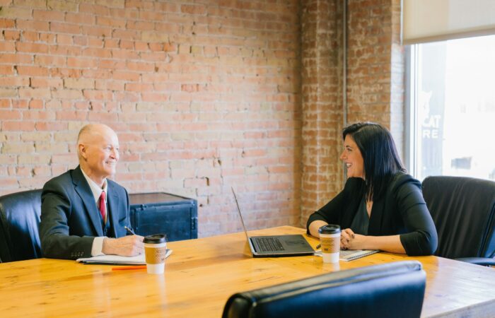 Man and woman inside office laughing together