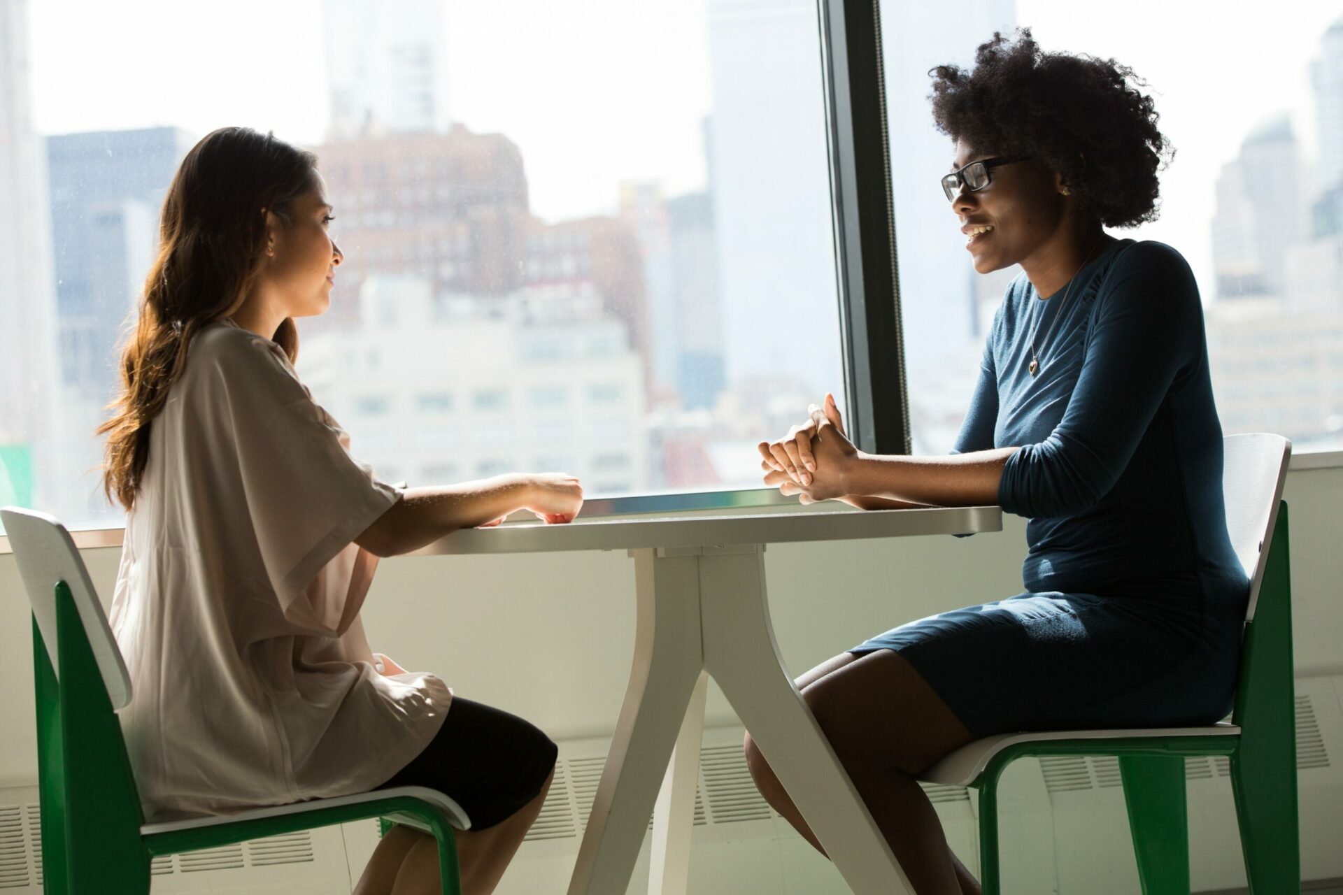 Two women discussing something at a table