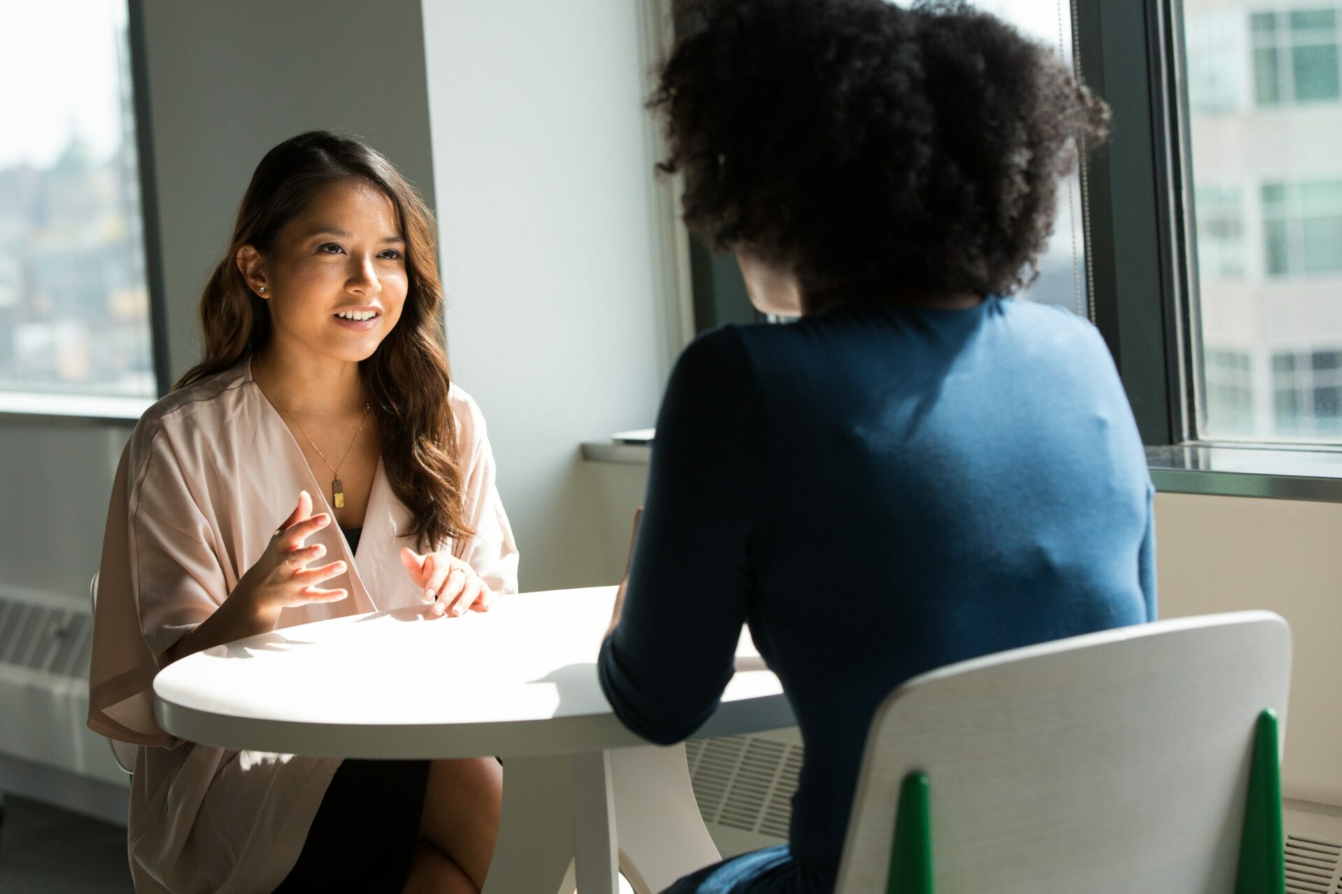 Two women discussing something at a table