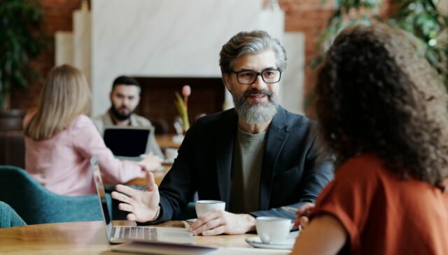 Room of various business people who are discussing business