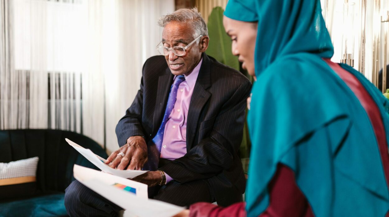 Man and woman discussing business holding print outs