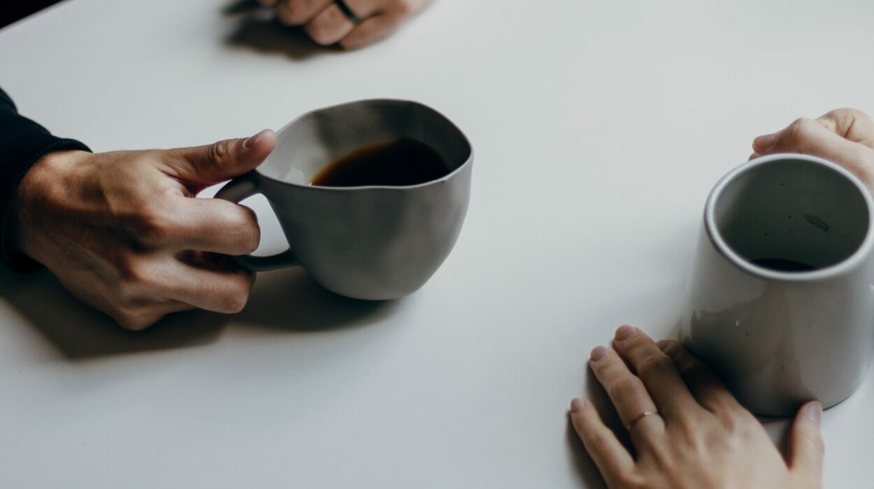 Close up of two people having a conversation over coffee