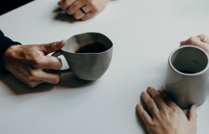 Close up of two people having a conversation over coffee
