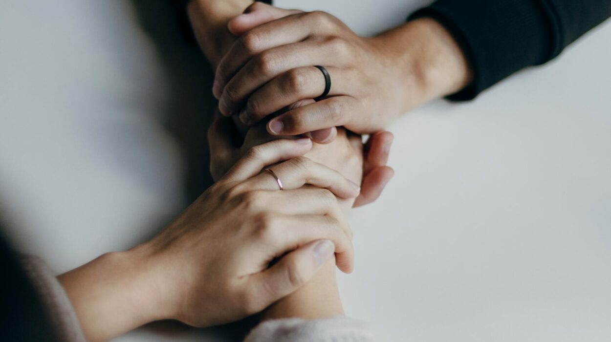 Close up of two people having a conversation and holding hands in support
