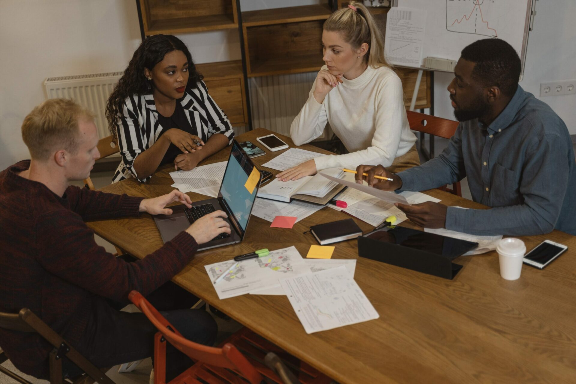A group of people sitting around a table in an office.
