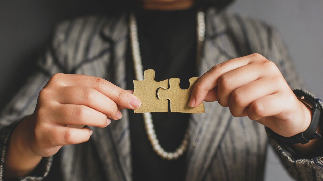 A woman holding two jigsaw puzzle pieces together