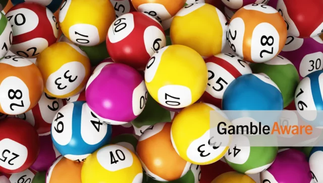 A lot of lottery balls. In the bottom-right corner is the 'GambleAware logo, and the 18+ only logo