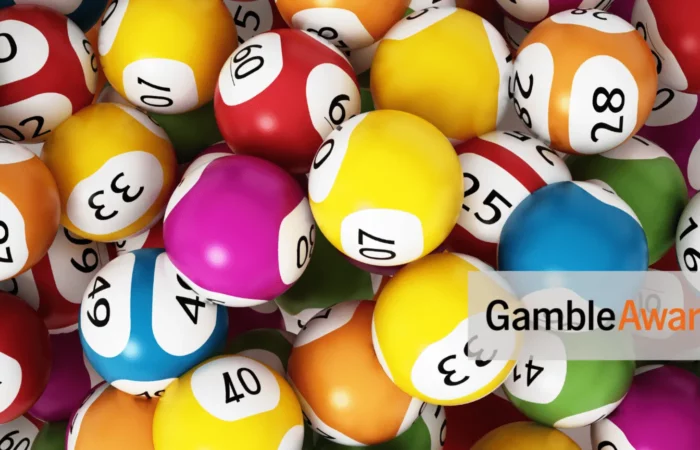A lot of lottery balls. In the bottom-right corner is the 'GambleAware logo, and the 18+ only logo