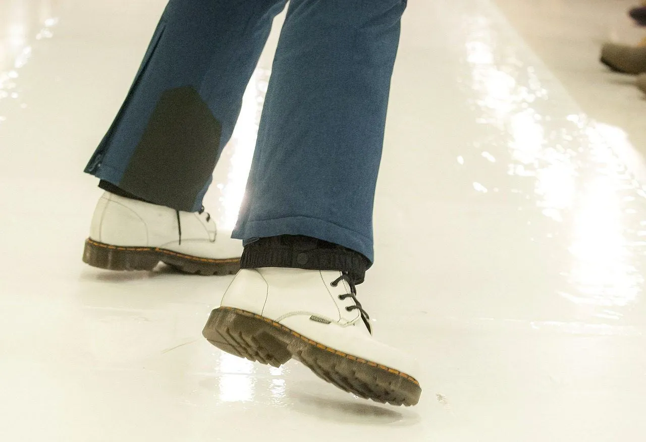 A person with white shoes looking as though they are stumbling