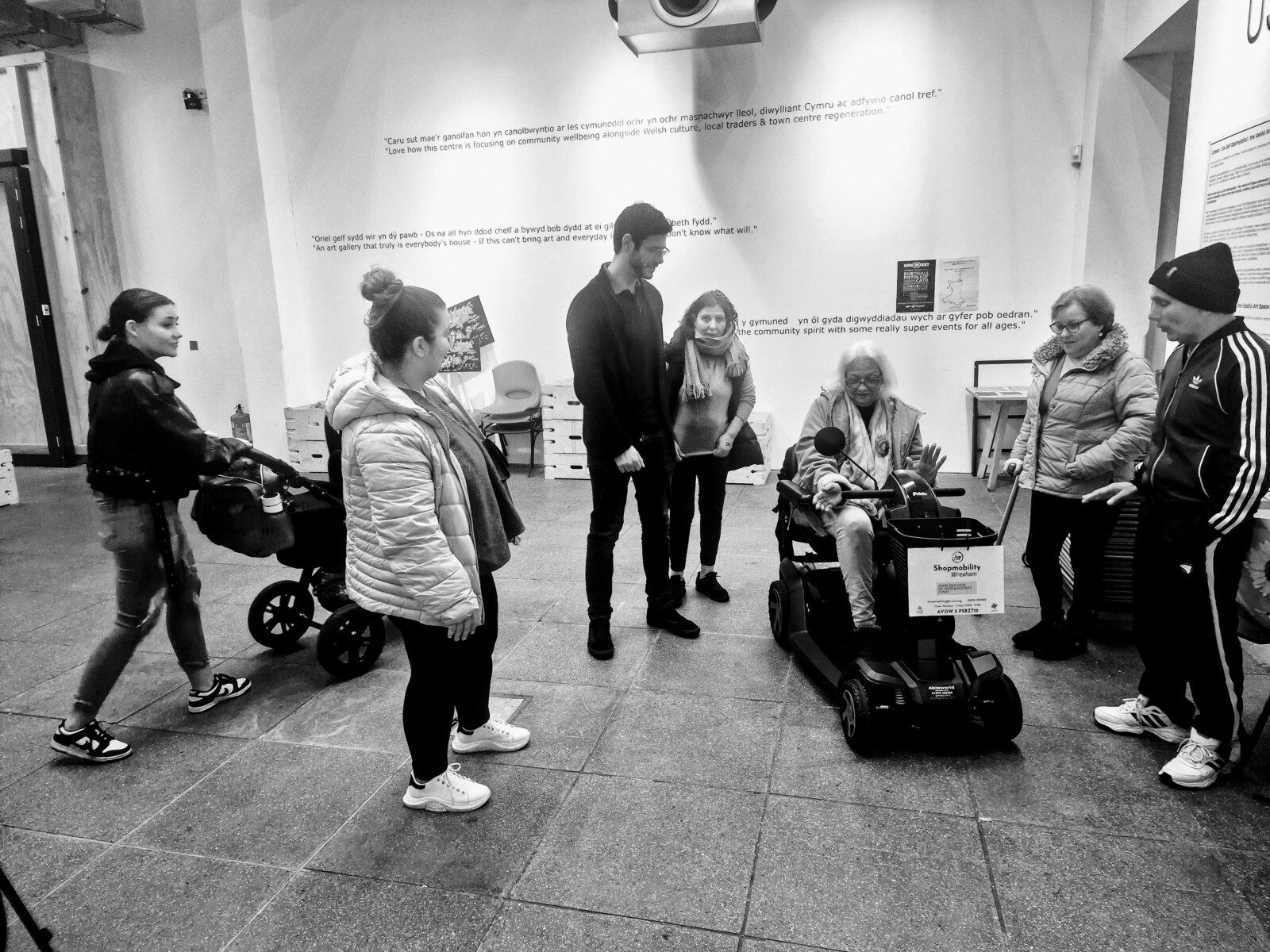A lady on a Shopmobility Scooter at Ty Pawb, with David McDonald supervising A lady on a Shopmobility Scooter at Ty Pawb, with David McDonald supervising