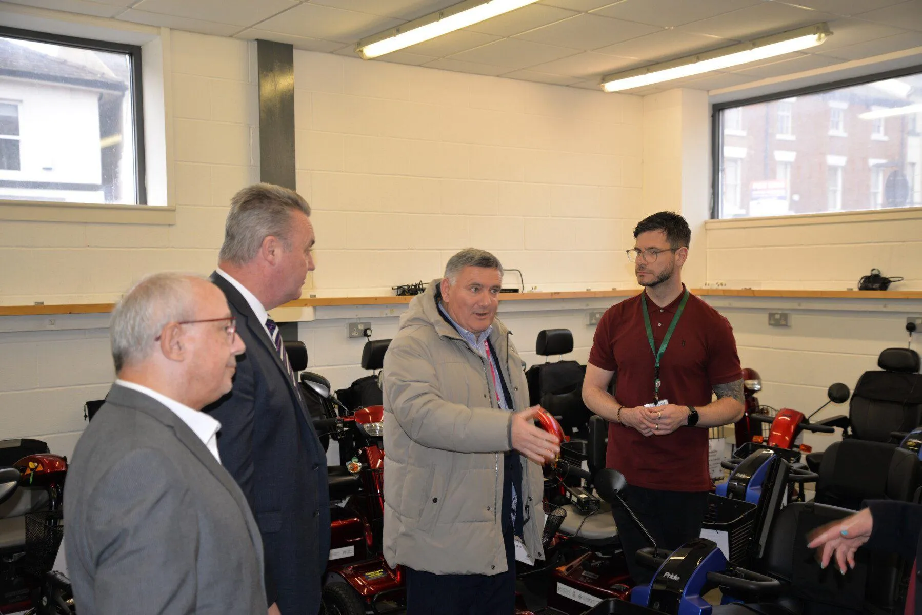 Meeting of Cllr Nigel Williams and Mark Pritchard - Group in the scooter store room Meeting of Cllr Nigel Williams and Mark Pritchard - Group in the scooter store room