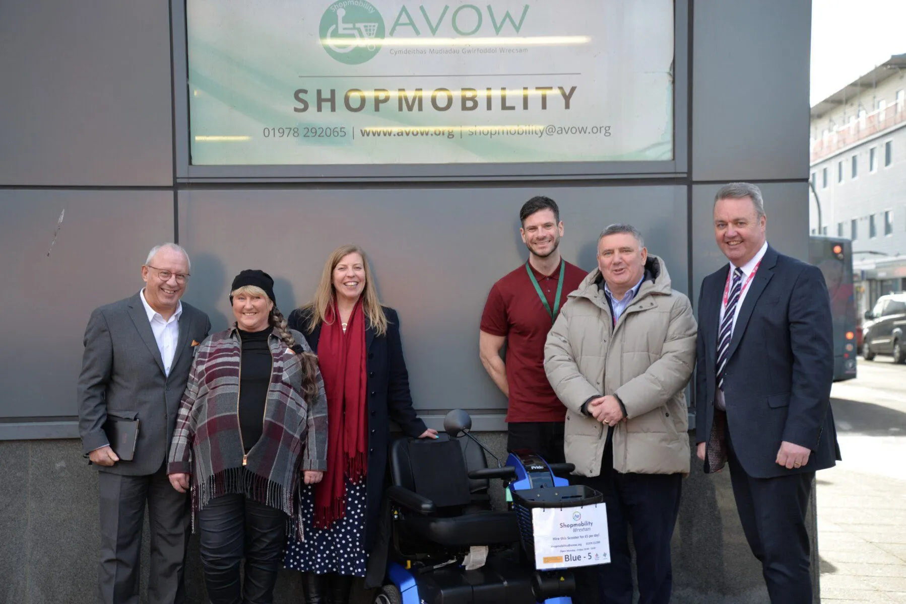 Pete Howell, Sharon Stoker, Dawn Roberts-McCabe, David McDonald, Mark Pritchard, Nigel Williams standing around a Shopmobility Scooter. Pete Howell, Sharon Stoker, Dawn Roberts-McCabe, David McDonald, Mark Pritchard, Nigel Williams standing around a Shopmobility Scooter.