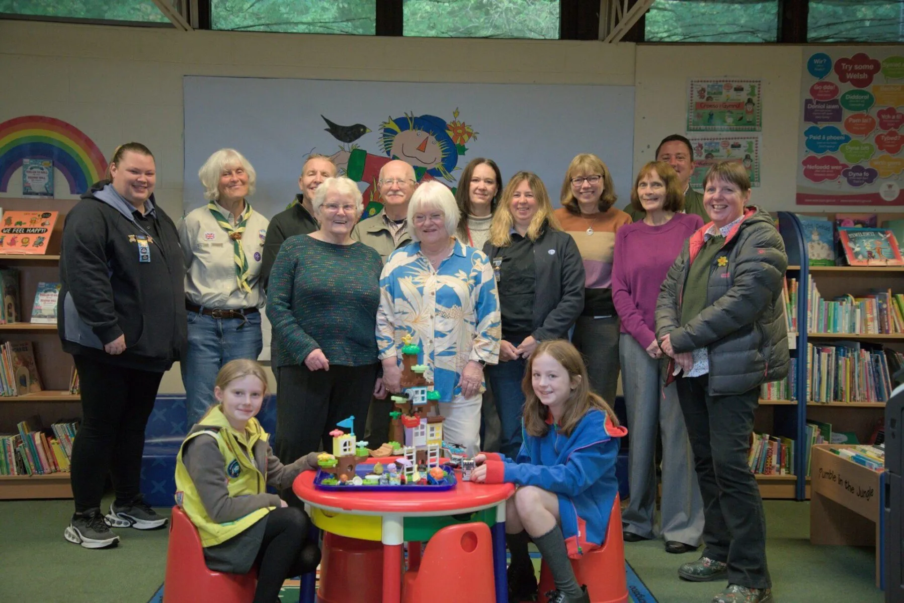 A group photo of all recipients of the money. 1st Moss Scouts (Sue Mort), Friends of Moss Valley, The Rainbow Foundation (Claire Partridge and Ian Pope), Brynteg Library, AVOW (Jo Young), 1st Brynteg Guides Rainbows and Brownies (Catriona Kempster) and members of the retiring members of the Broughton Community CIC (Eva Thomspon and Irene Jones).