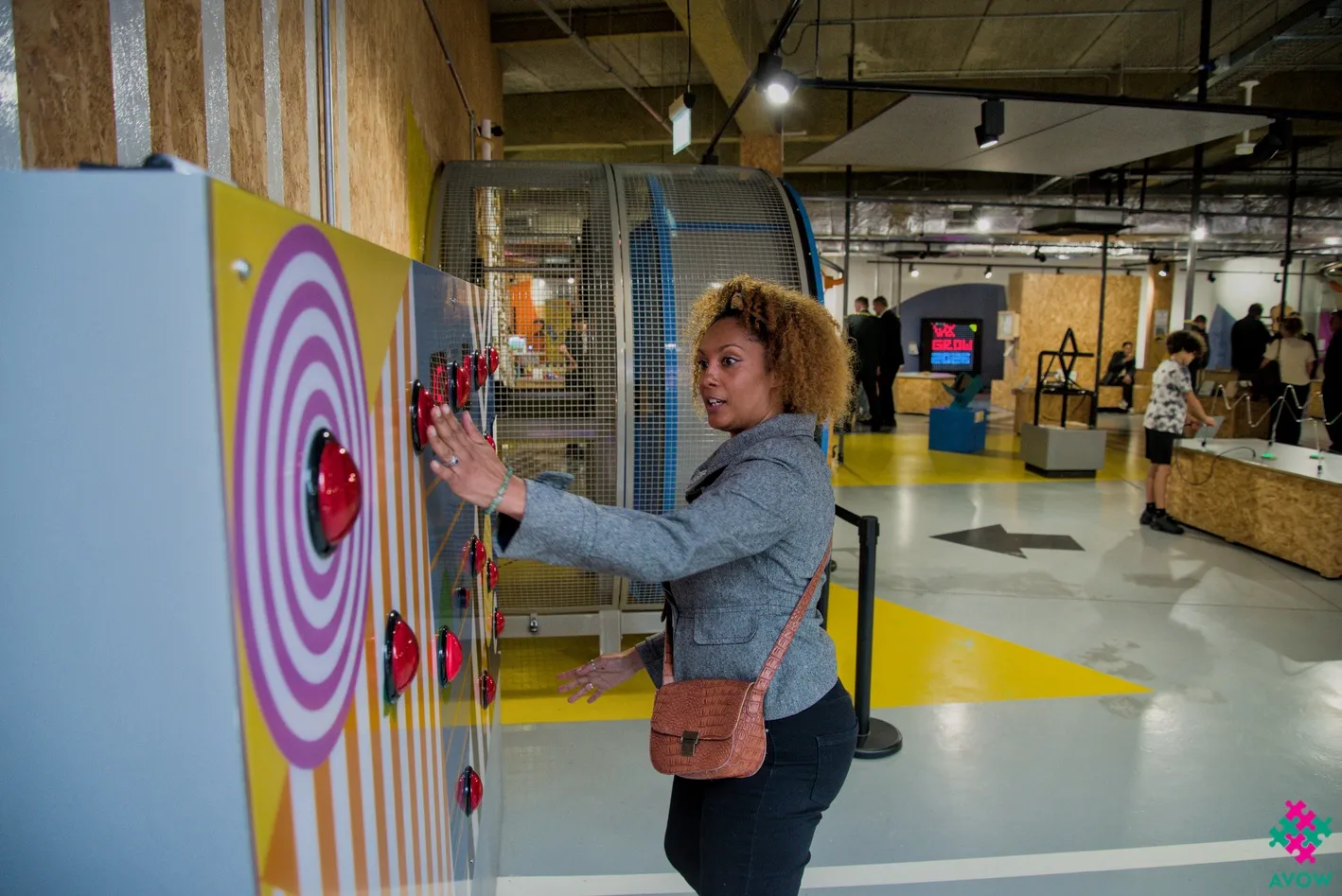 A woman playing on a reaction time wall A woman playing on a reaction time wall