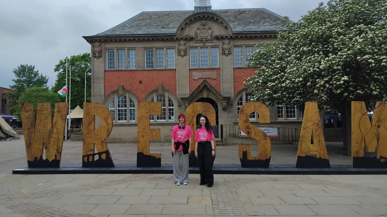 AVOW Volunteers infront of the Wrecsam sign in Queen's Square