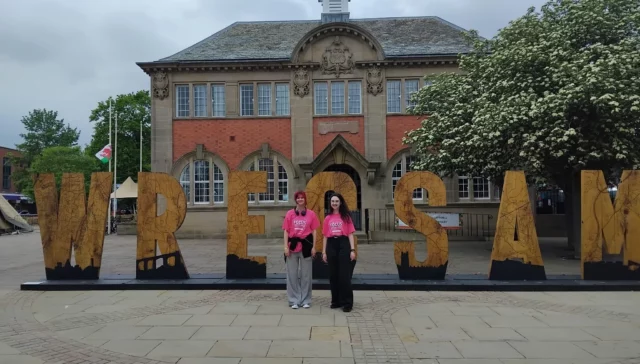 AVOW Volunteers infront of the Wrecsam sign in Queen's Square