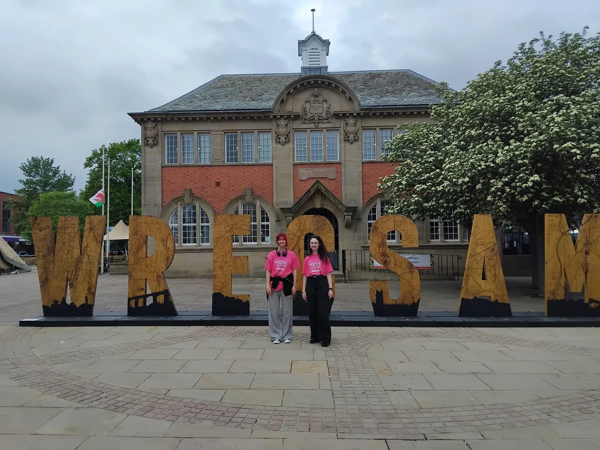 AVOW Volunteers infront of the Wrecsam sign in Queen's Square