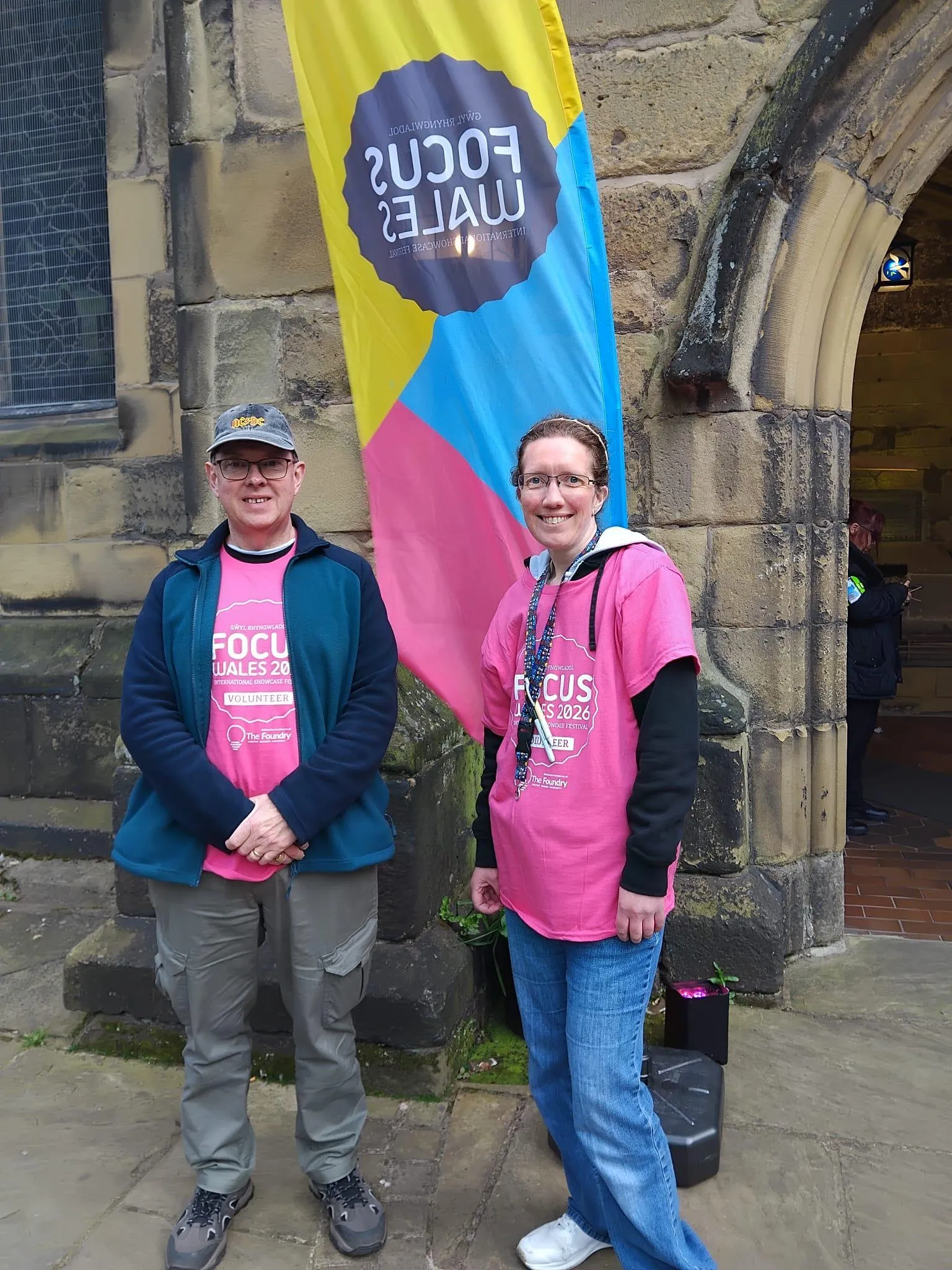 AVOW Volunteers in front of the Focus Wales banner