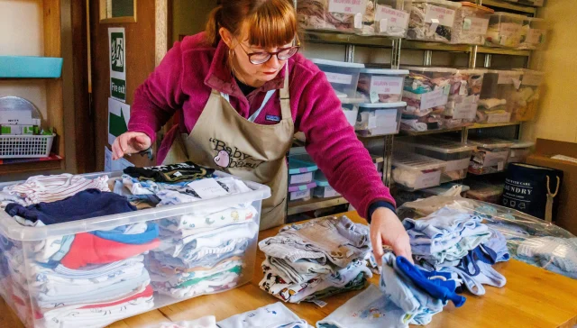 Baby Basics: Women sorting clothes.
