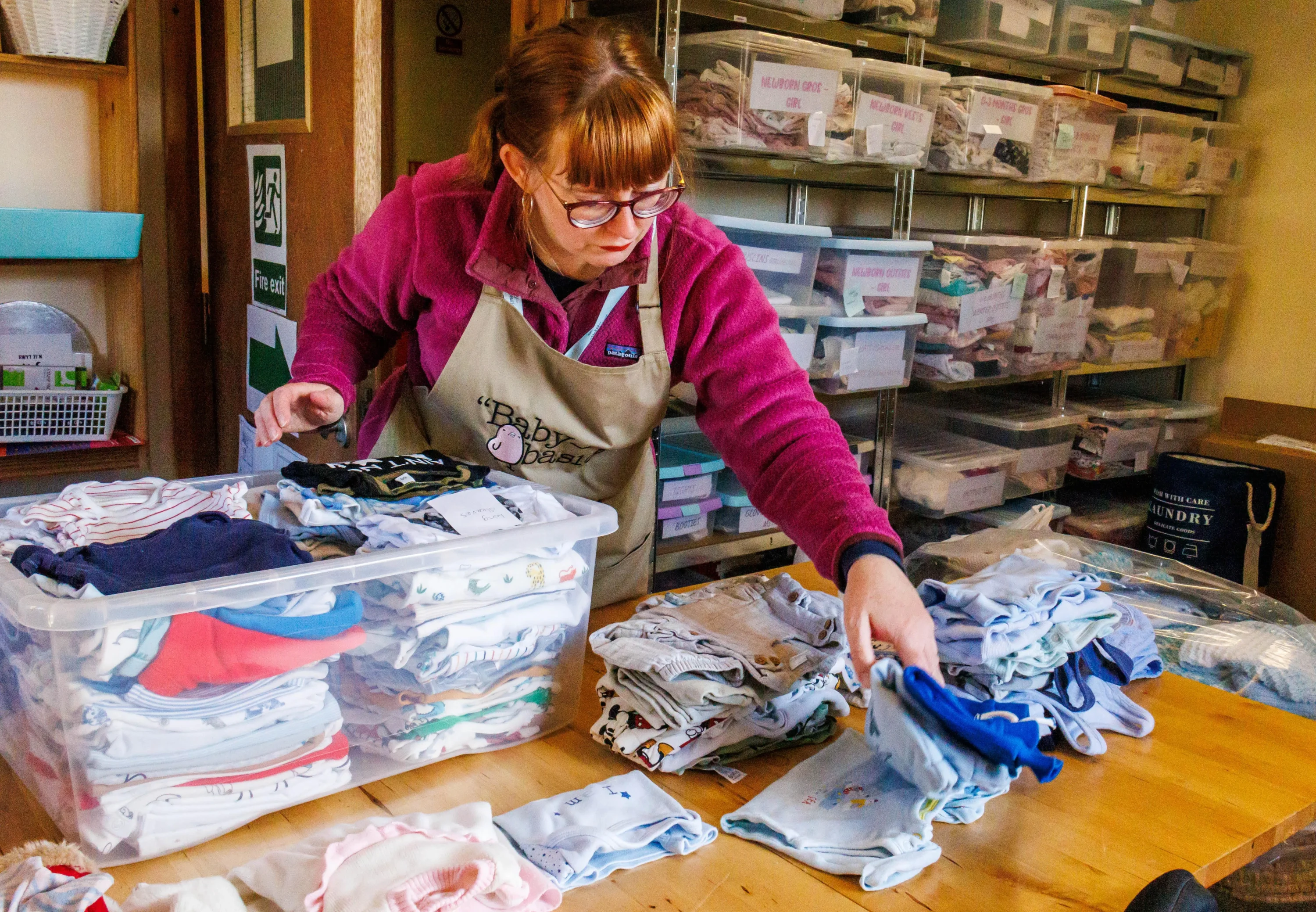Baby Basics: Women sorting clothes.